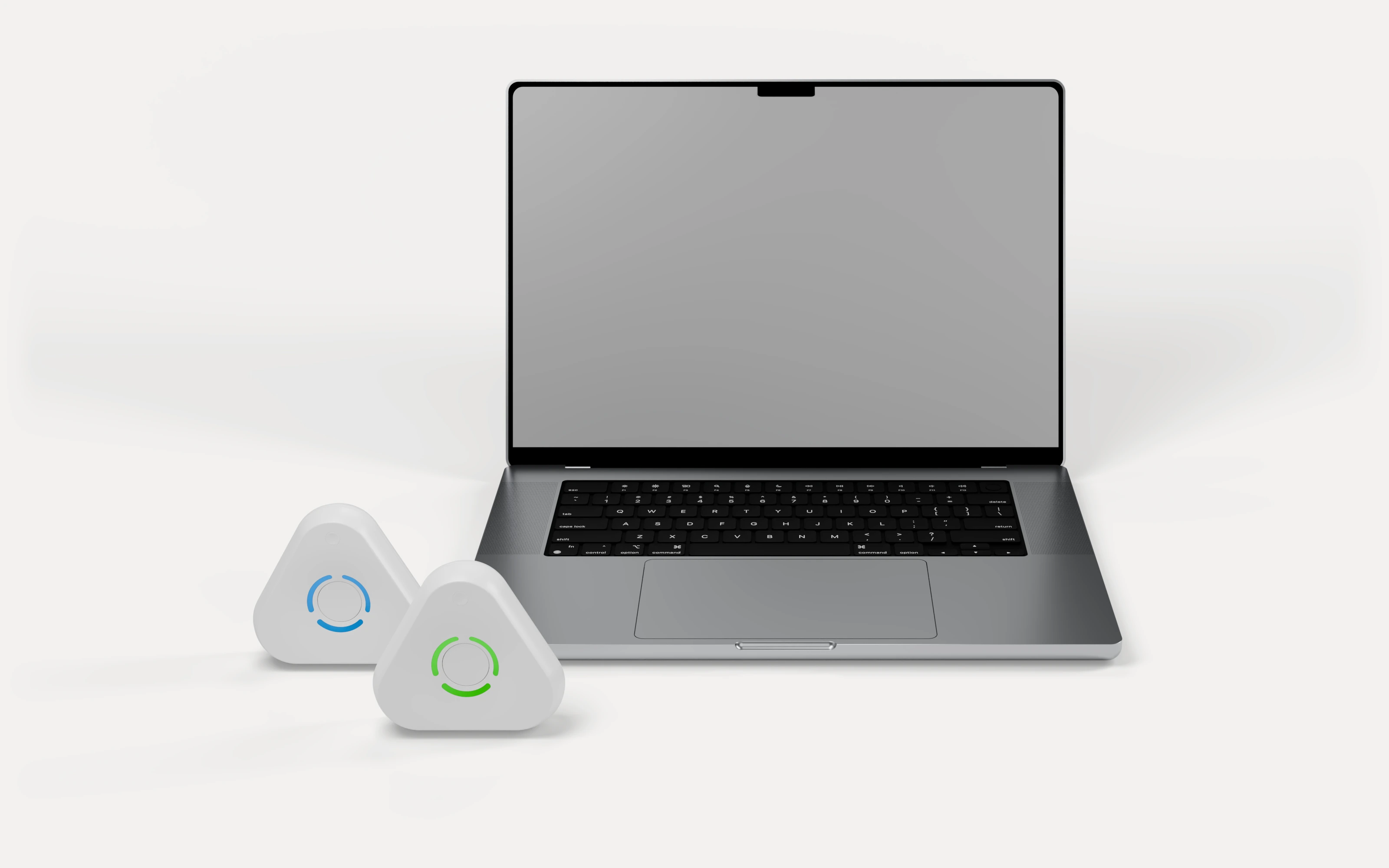 Two Estimote UWB anchors to the left of a laptop