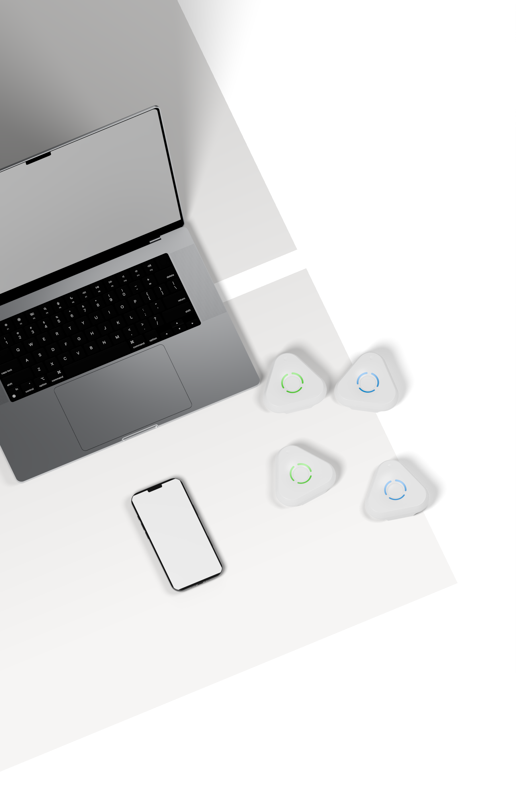 A Space Gray laptop, a black-framed phone and four lying Estimote UWB anchors on light gray and white panels